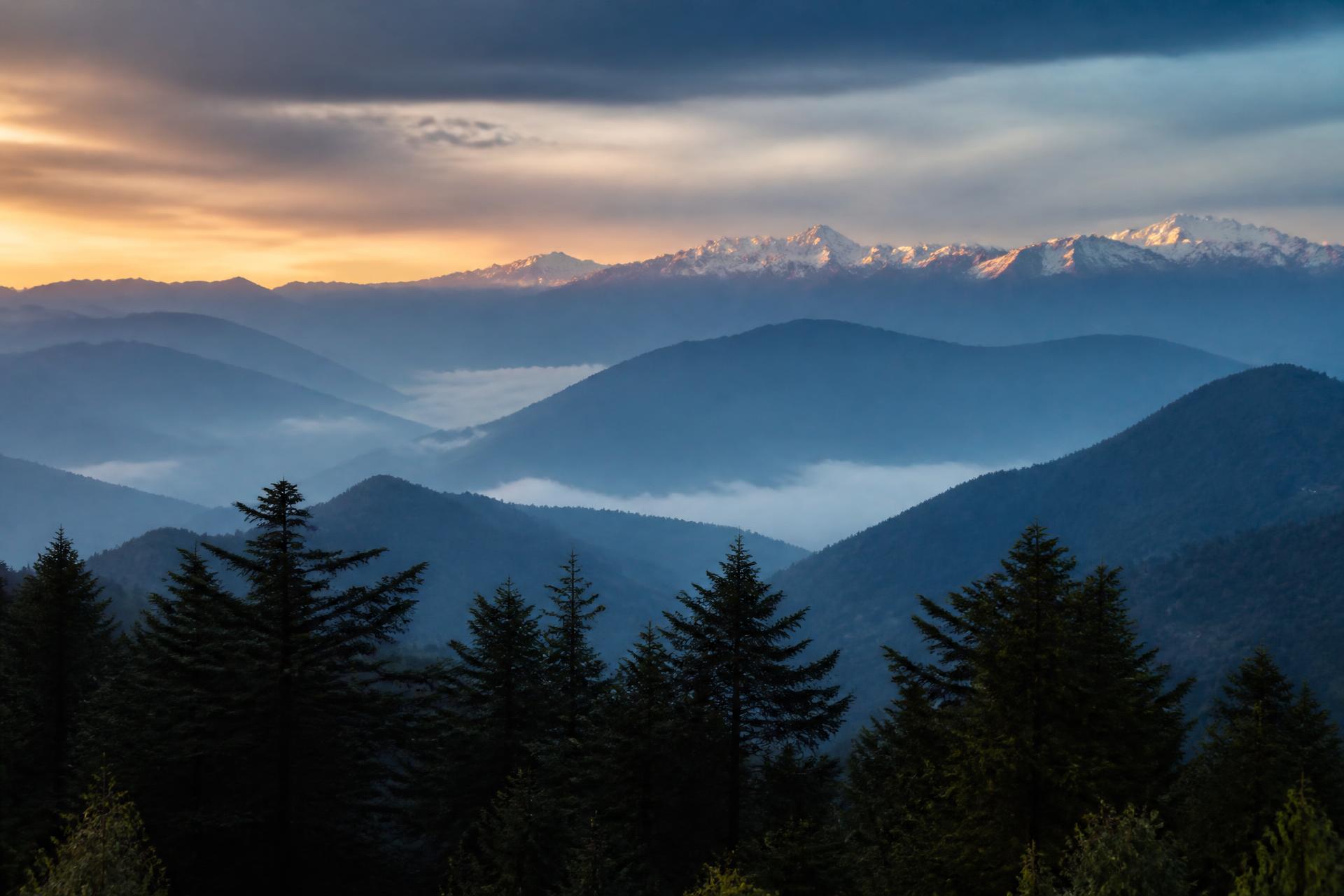 Mist drifting over layered Himalayan ridges near Nainital at dusk
